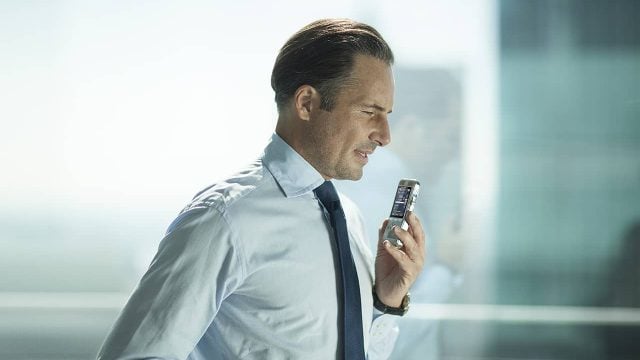 businessman-holding-dictation-machine